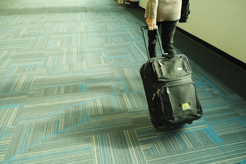 Traveler with luggage at Adelaide airport arrivals hall