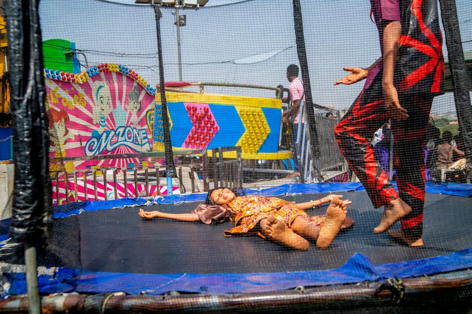 Children bouncing on trampolines at indoor play centre
