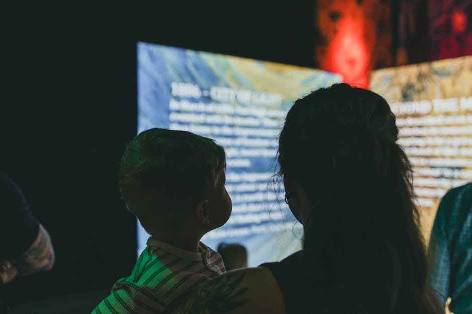 Family at interactive museum exhibit with children learning