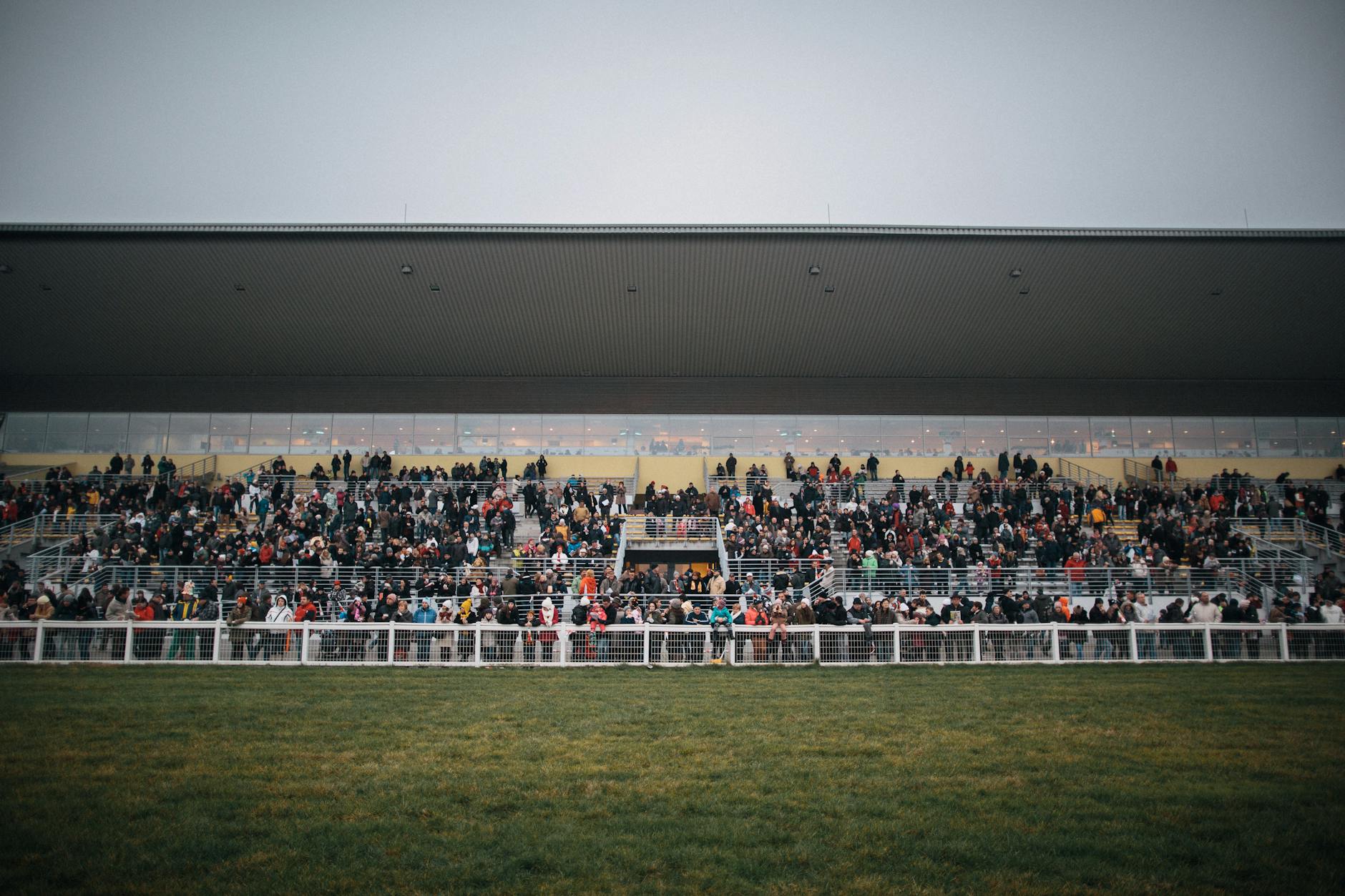Spectators in a packed grandstand at a Supercars race