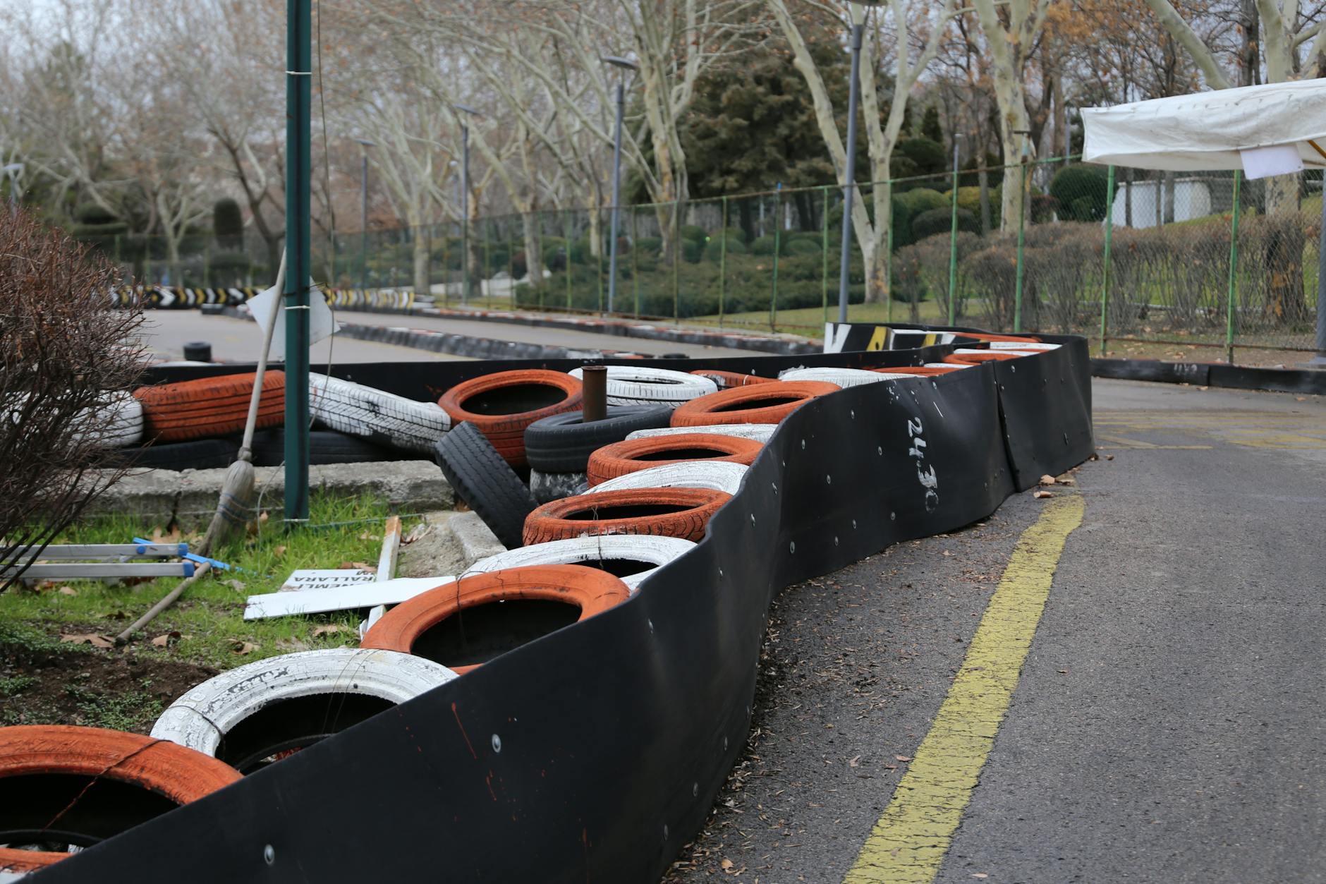Race cars on a temporary street circuit lined with concrete barriers