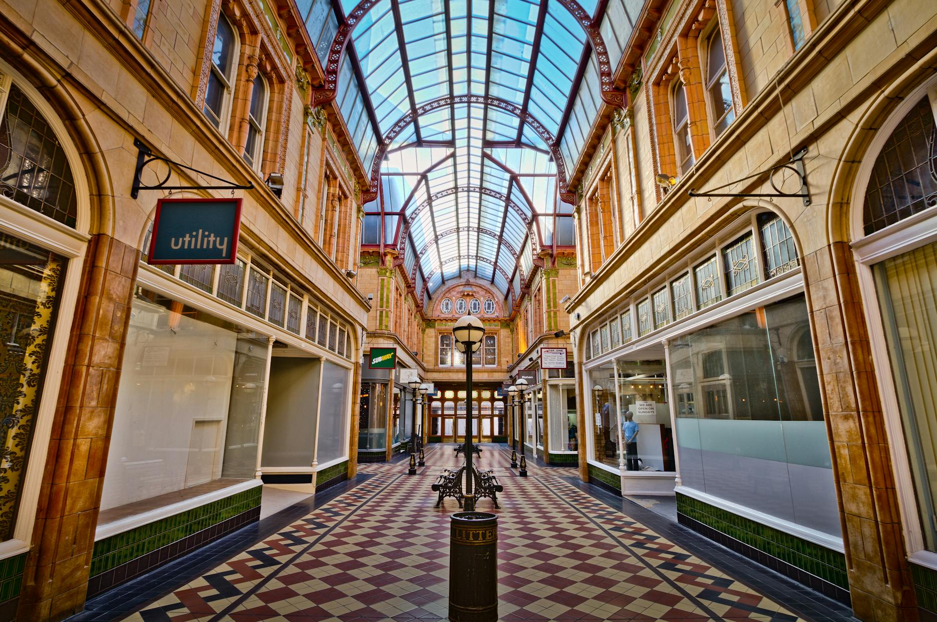 Victorian shopping arcade with tiled floor and wrought-iron detailing, like the Adelaide Arcade