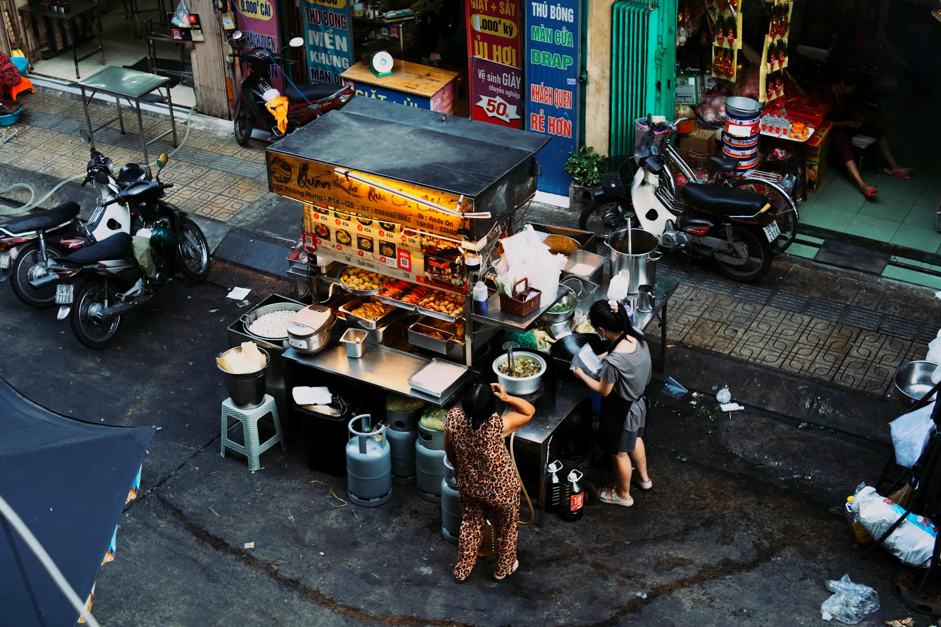 Asian street food being prepared at a busy market stall