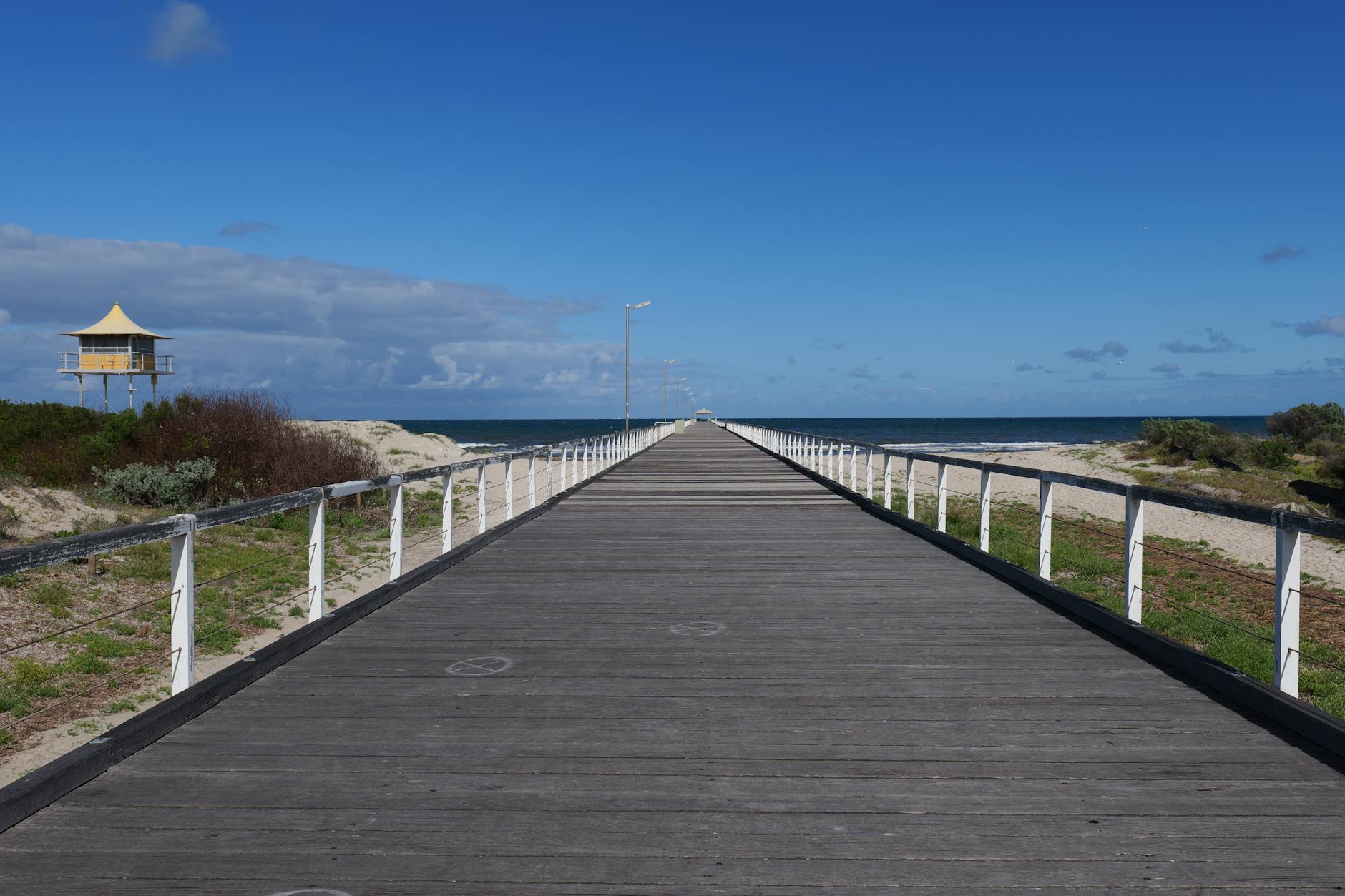 A sunny Adelaide beach in summer with light clothing and swimwear