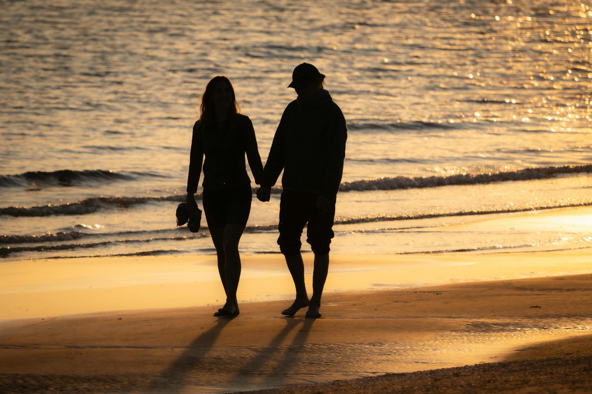 Couple walking on the beach at sunset near Adelaide