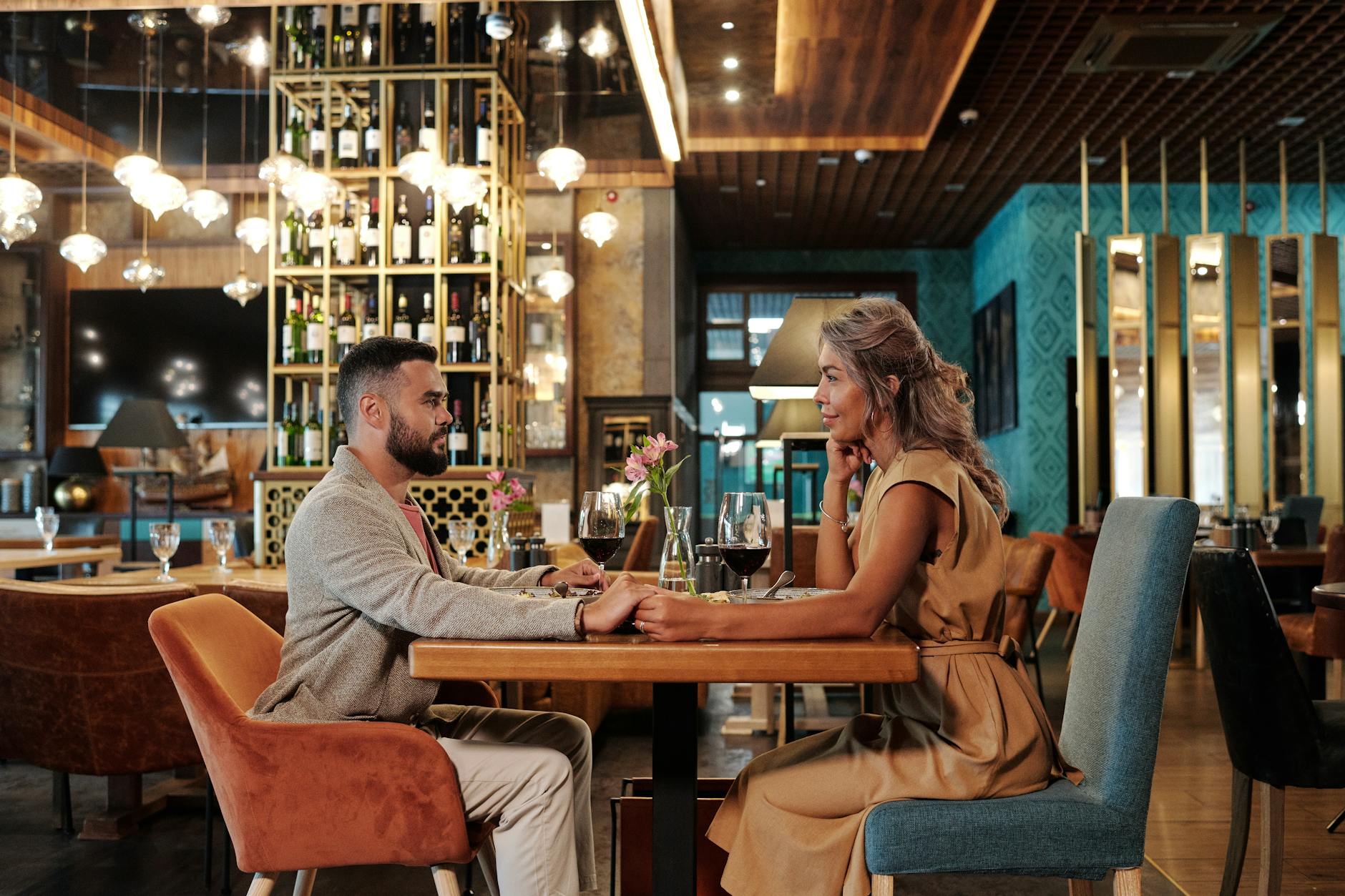 A couple sharing a candle-lit dinner on a romantic Adelaide date night