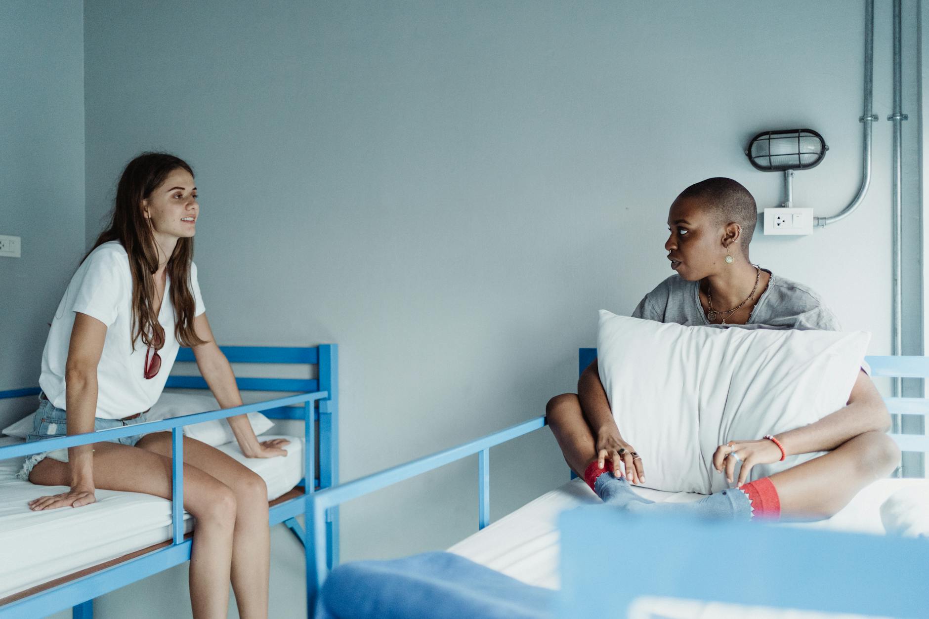 Travellers relaxing in a social hostel common room lounge