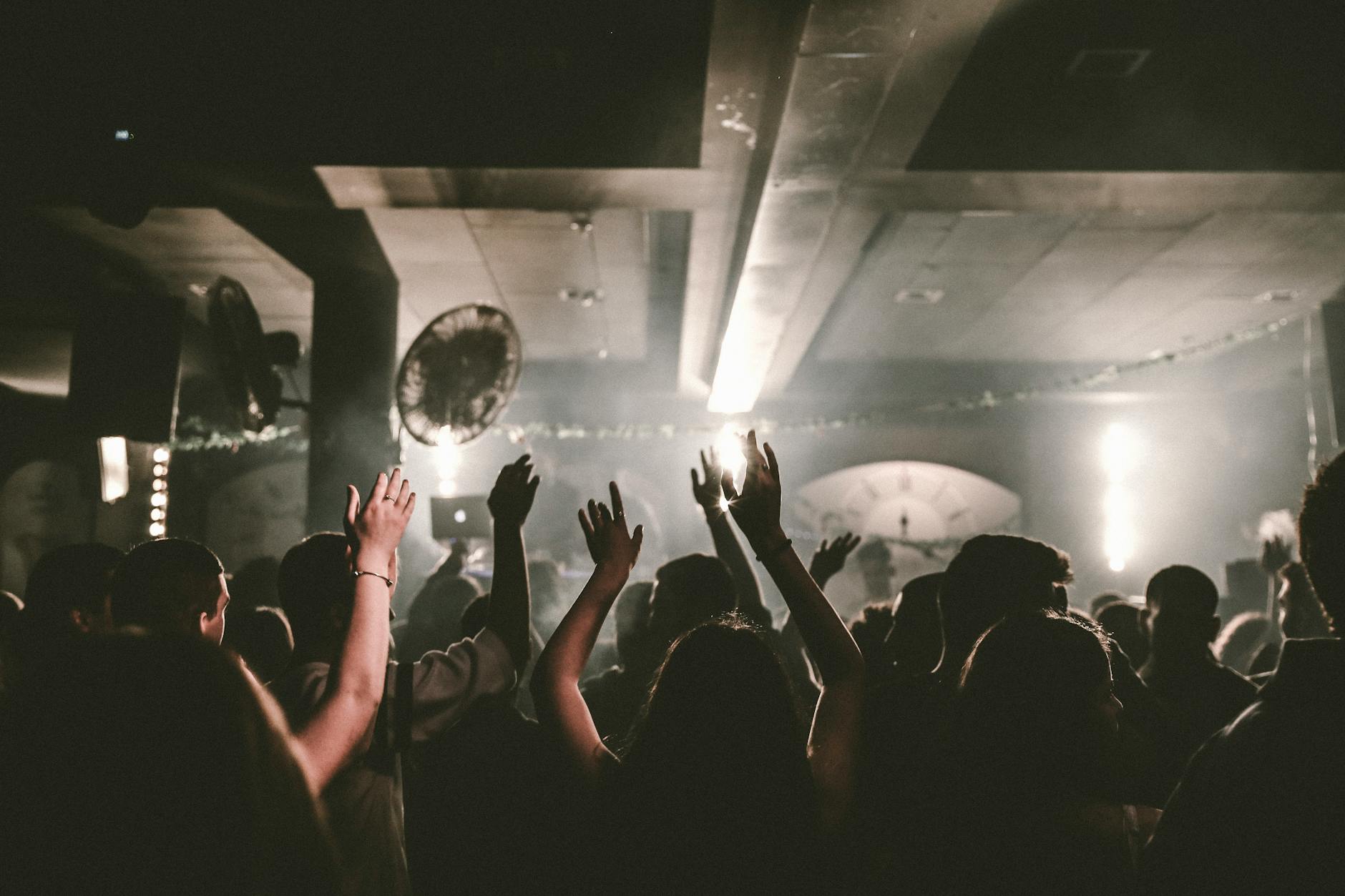 Crowd dancing under coloured lights on a nightclub dance floor in Adelaide