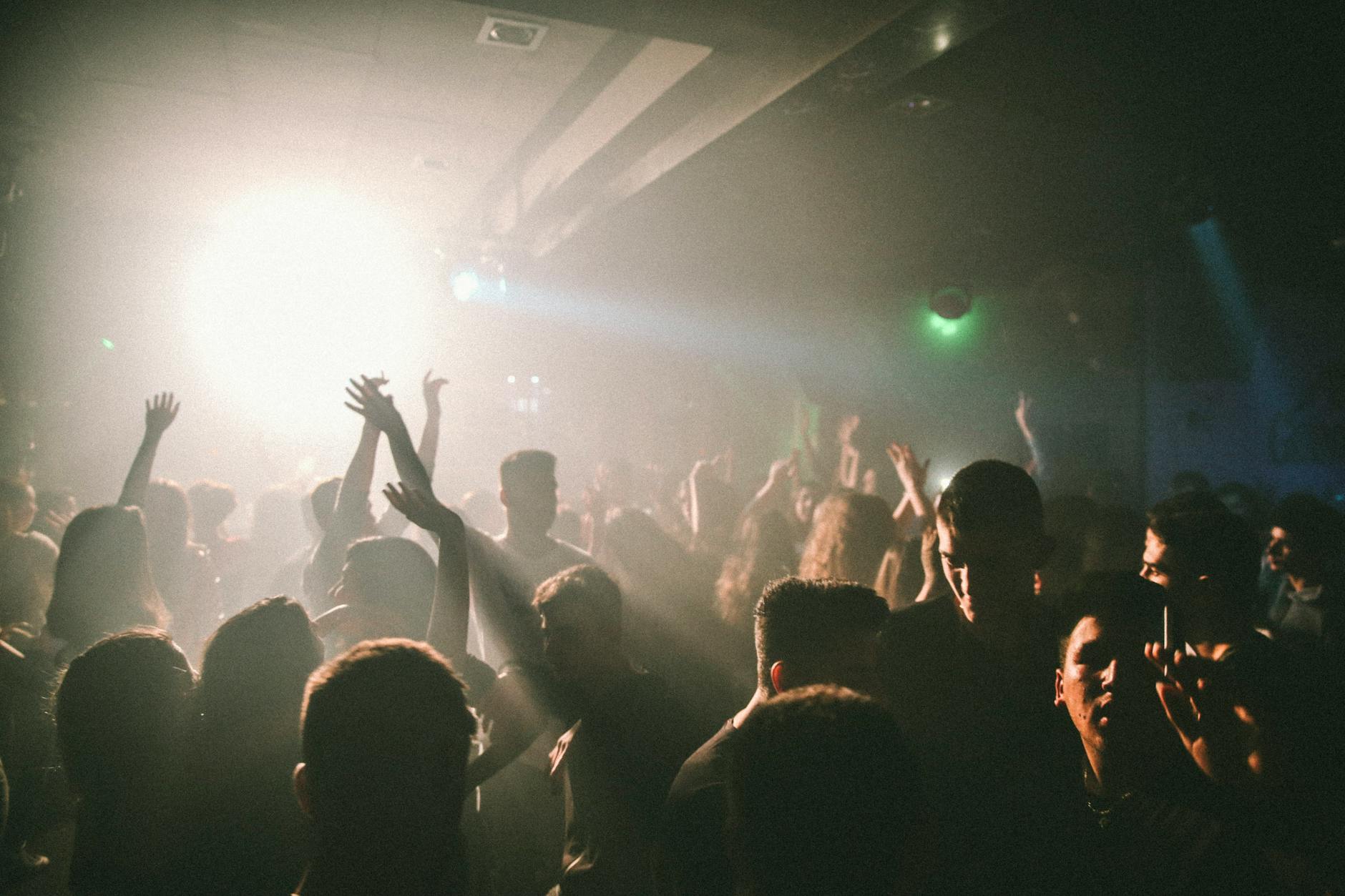 A crowded nightclub dance floor lit by coloured lights, the heart of Adelaide nightlife after dark