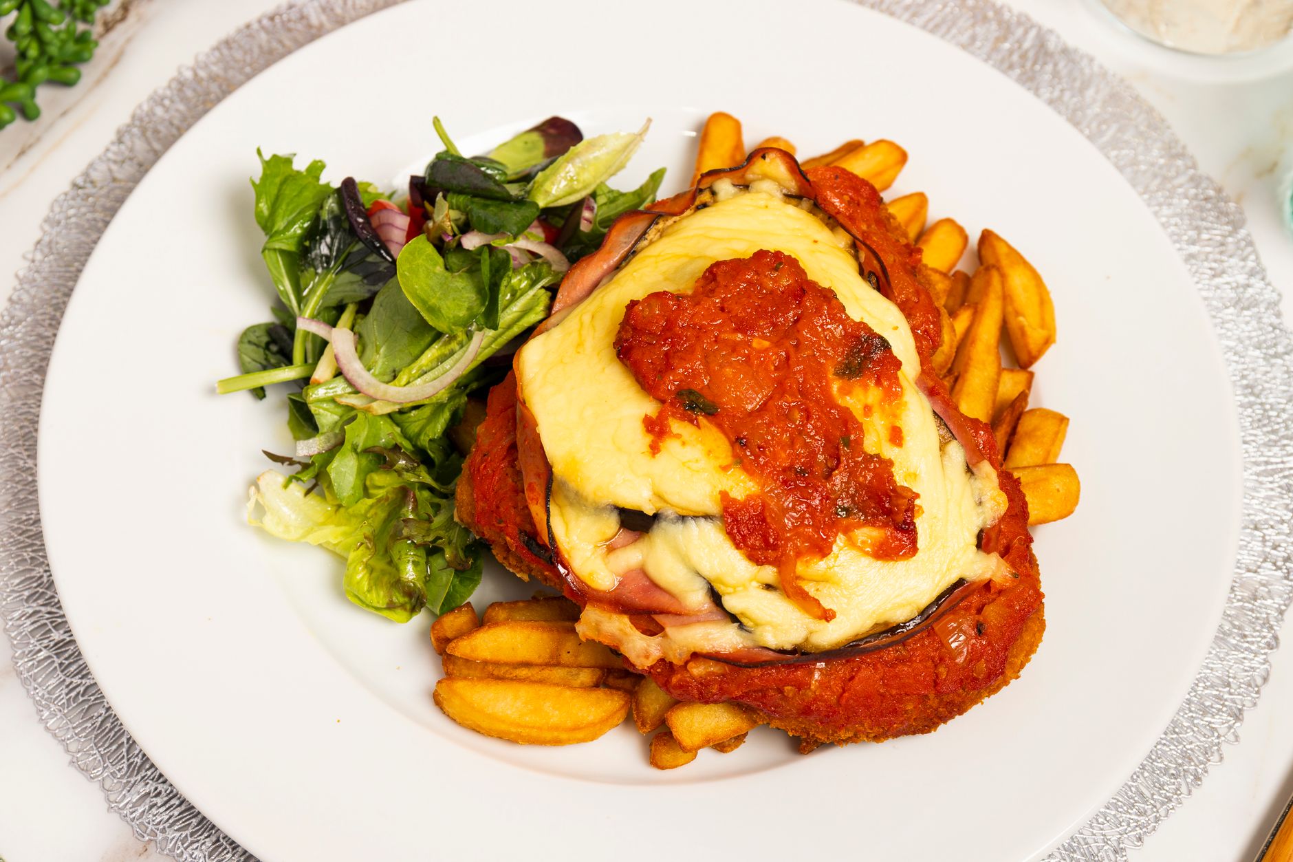 Chicken parmigiana with chips, a classic Adelaide pub parmy