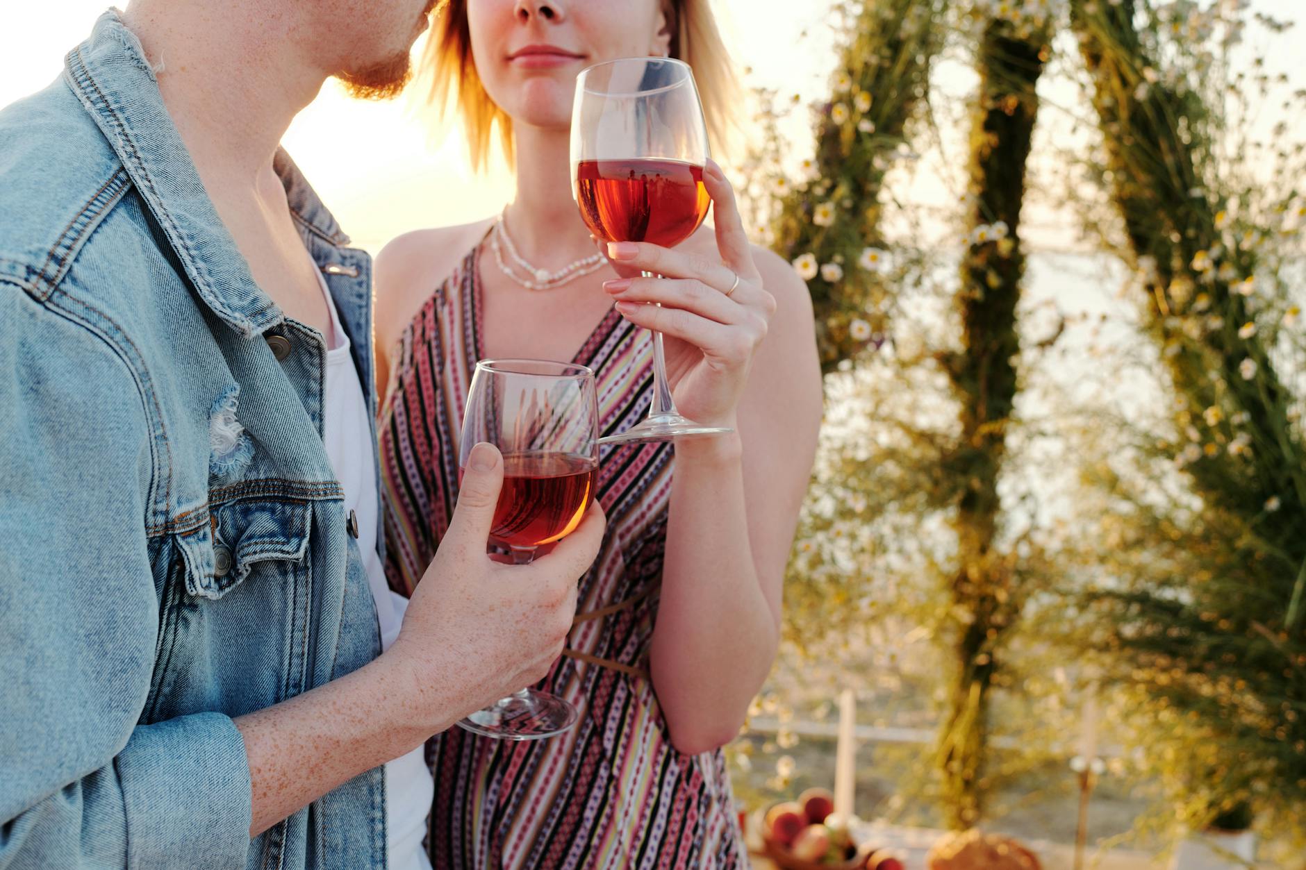A couple sharing wine among the vines on an Adelaide romantic getaway