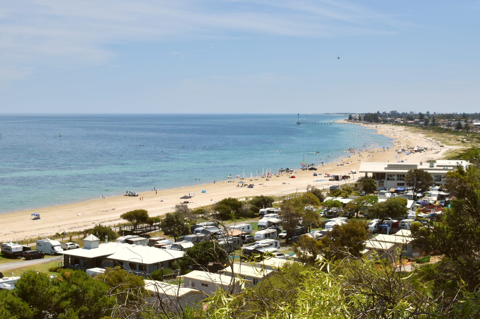 Swimmers and families on Glenelg beach in Adelaide during summer