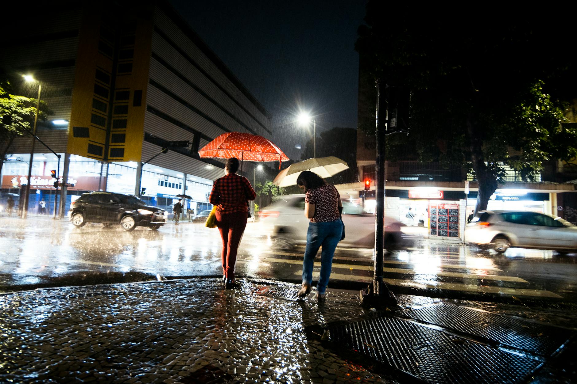 A person with an umbrella on a wet city street, packing for Adelaide winter