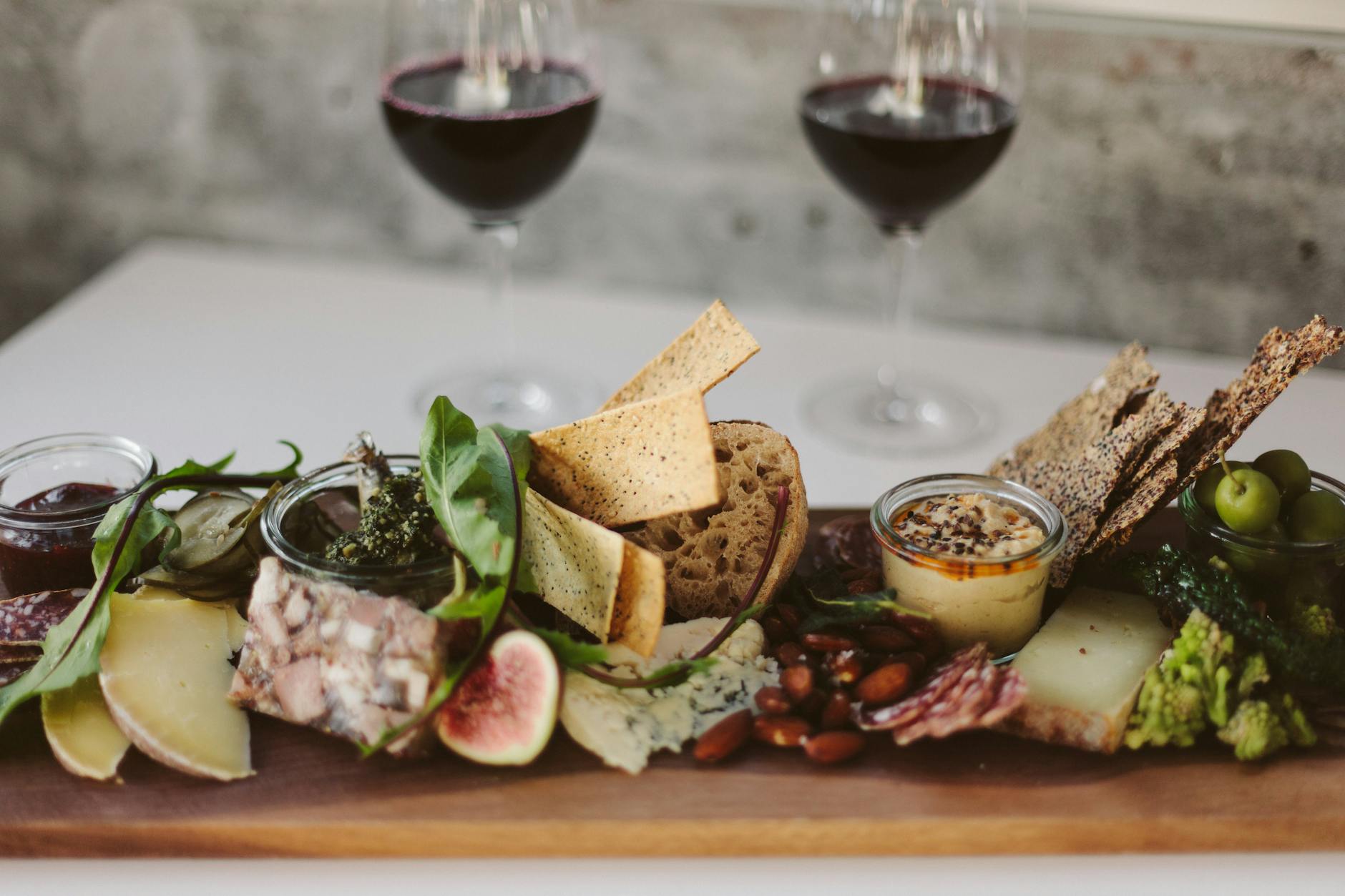 A cheese and charcuterie platter with wine at a Barossa cellar door