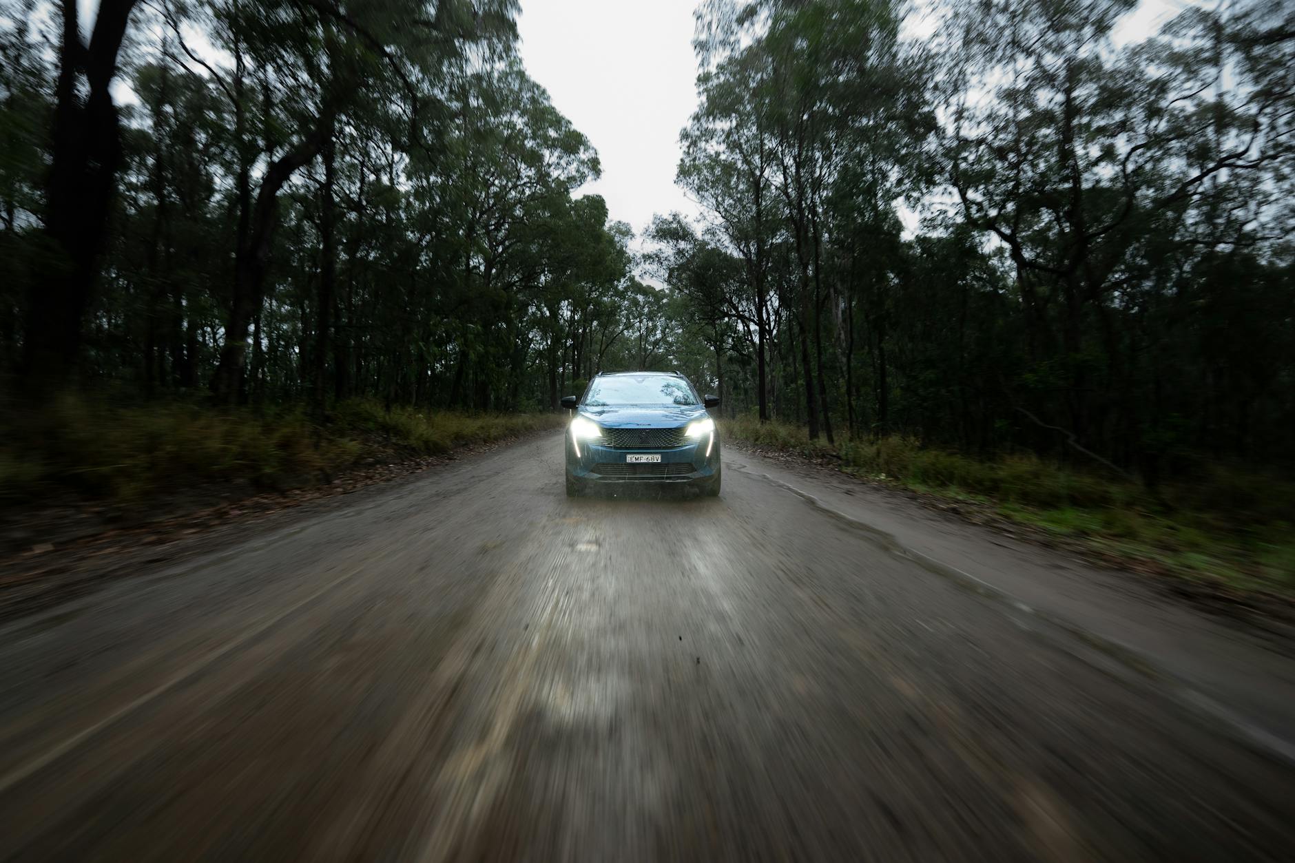 A car on a long outback road heading into the Flinders Ranges