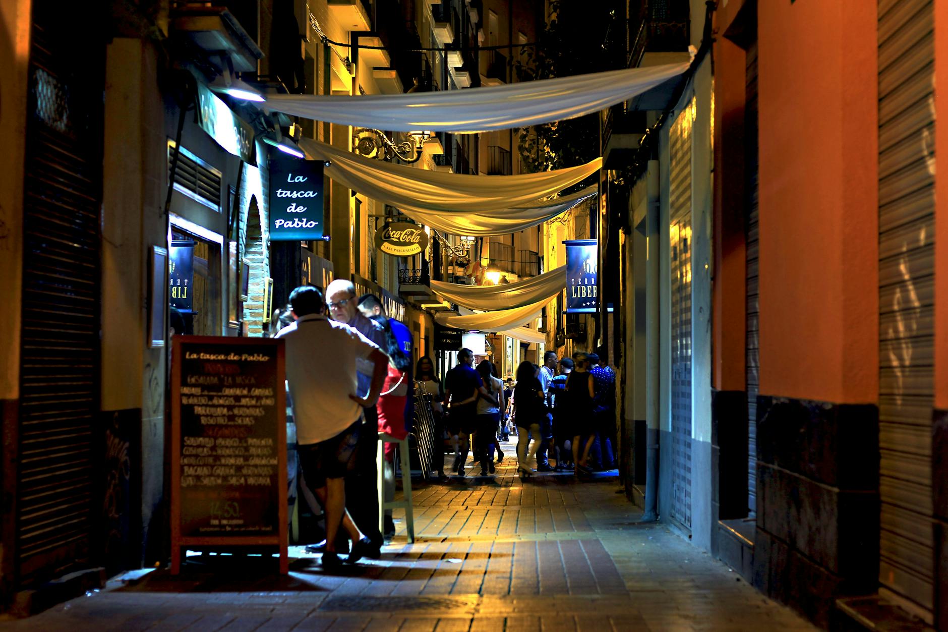 A neon-lit nightlife street at night, evoking Adelaide's Hindley Street strip