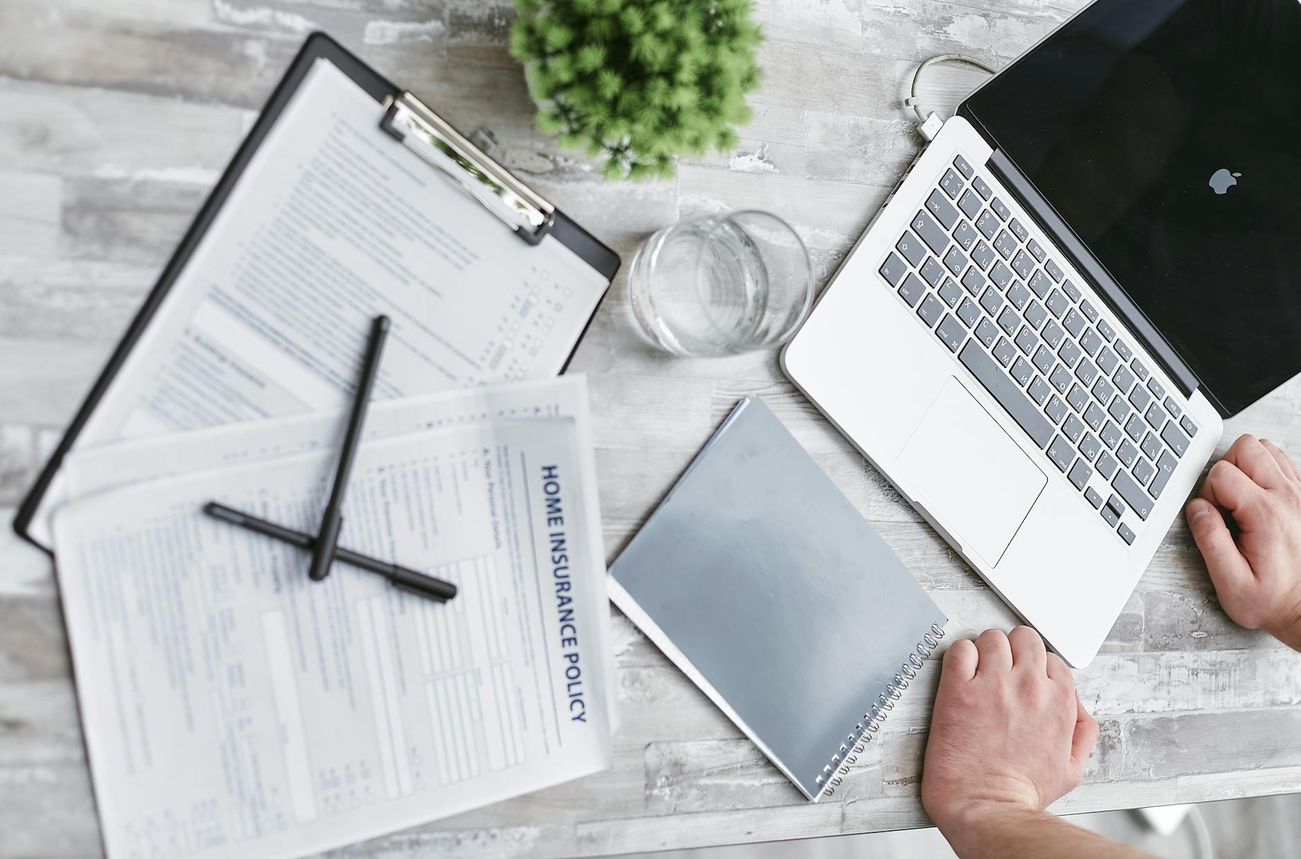 Car rental insurance documents and keys on a desk