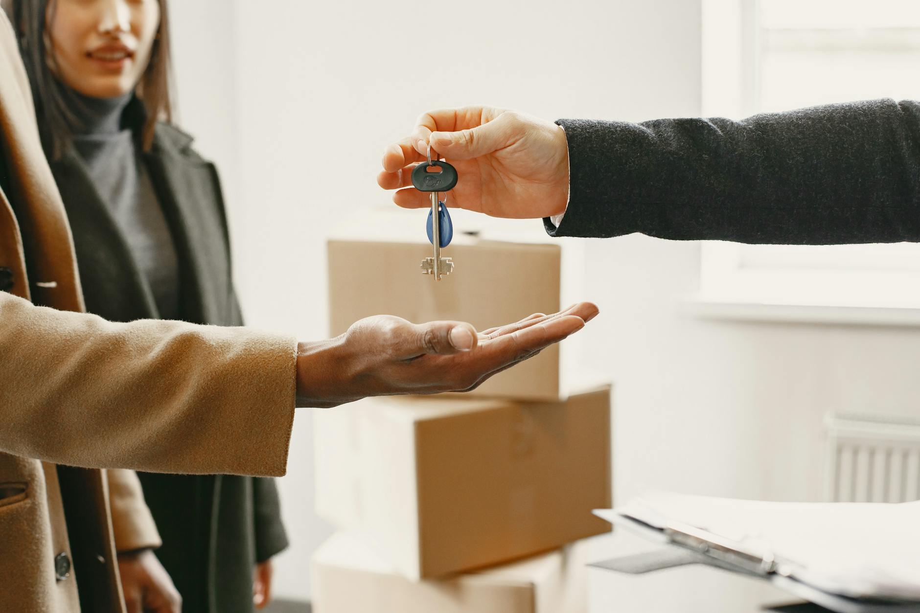 Car rental agreement handover with keys and paperwork