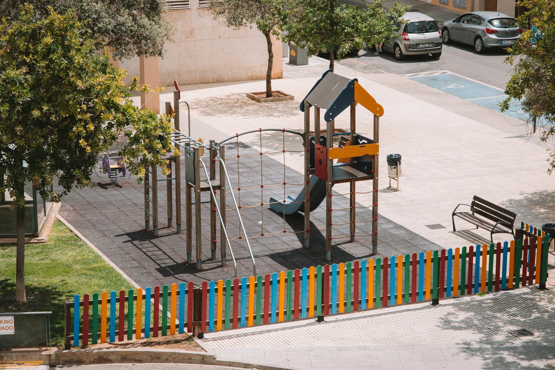 Fenced toddler playground with safe age-appropriate equipment
