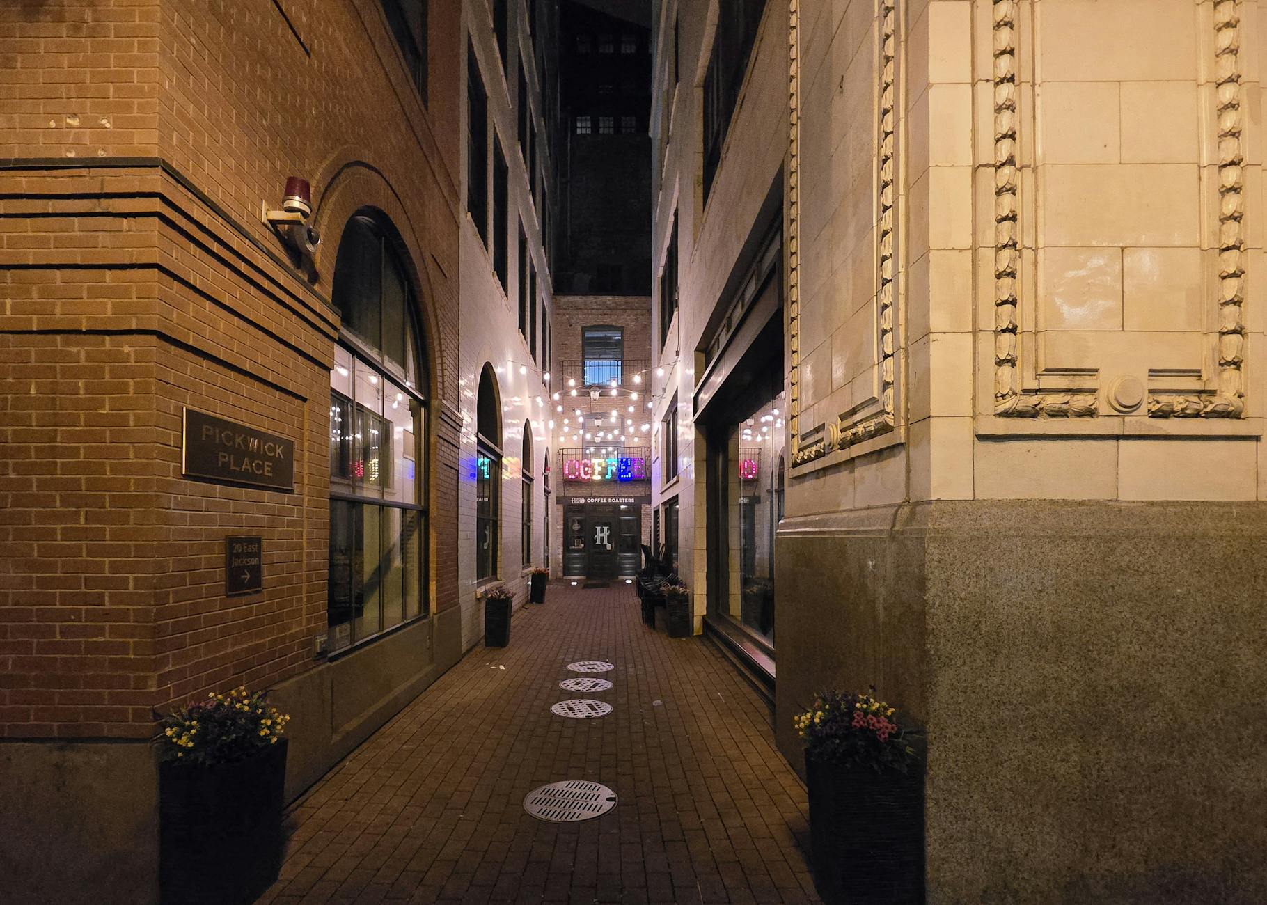 Narrow Adelaide laneway at night with string lights and bar entrances