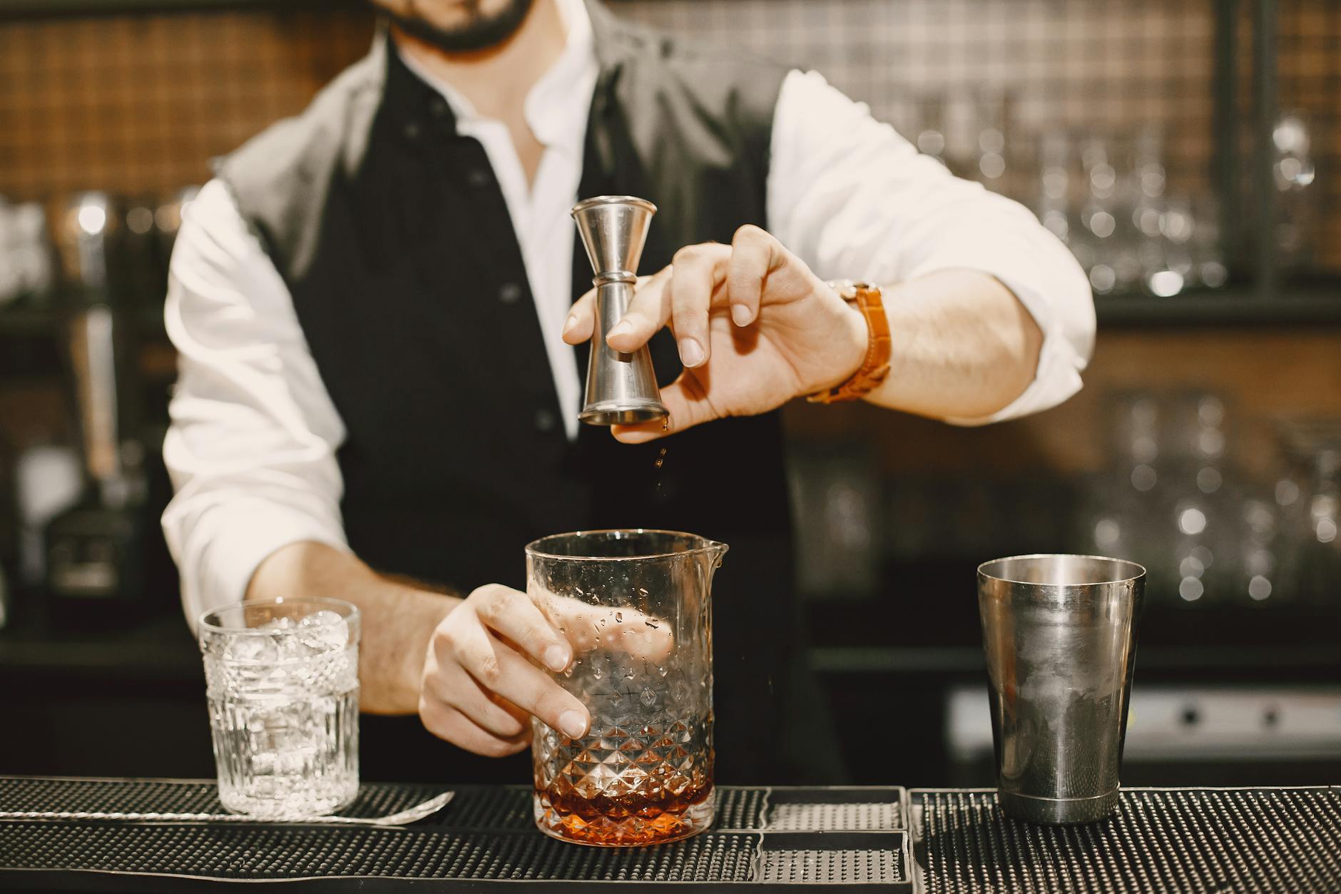 Bartender mixing craft cocktails at an Adelaide small bar