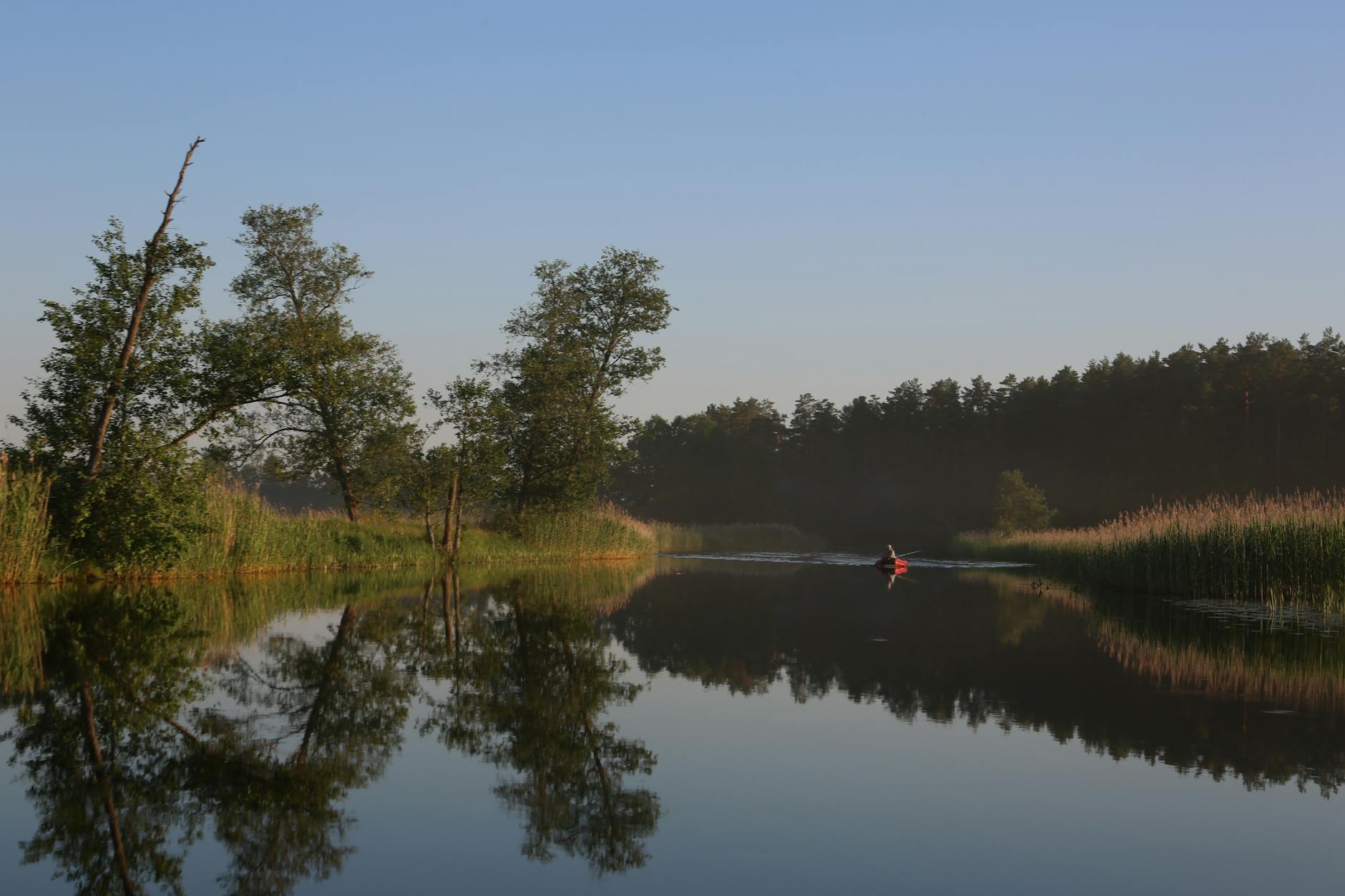 A kayaker paddling on the calm flat water of Torrens Lake in Adelaide