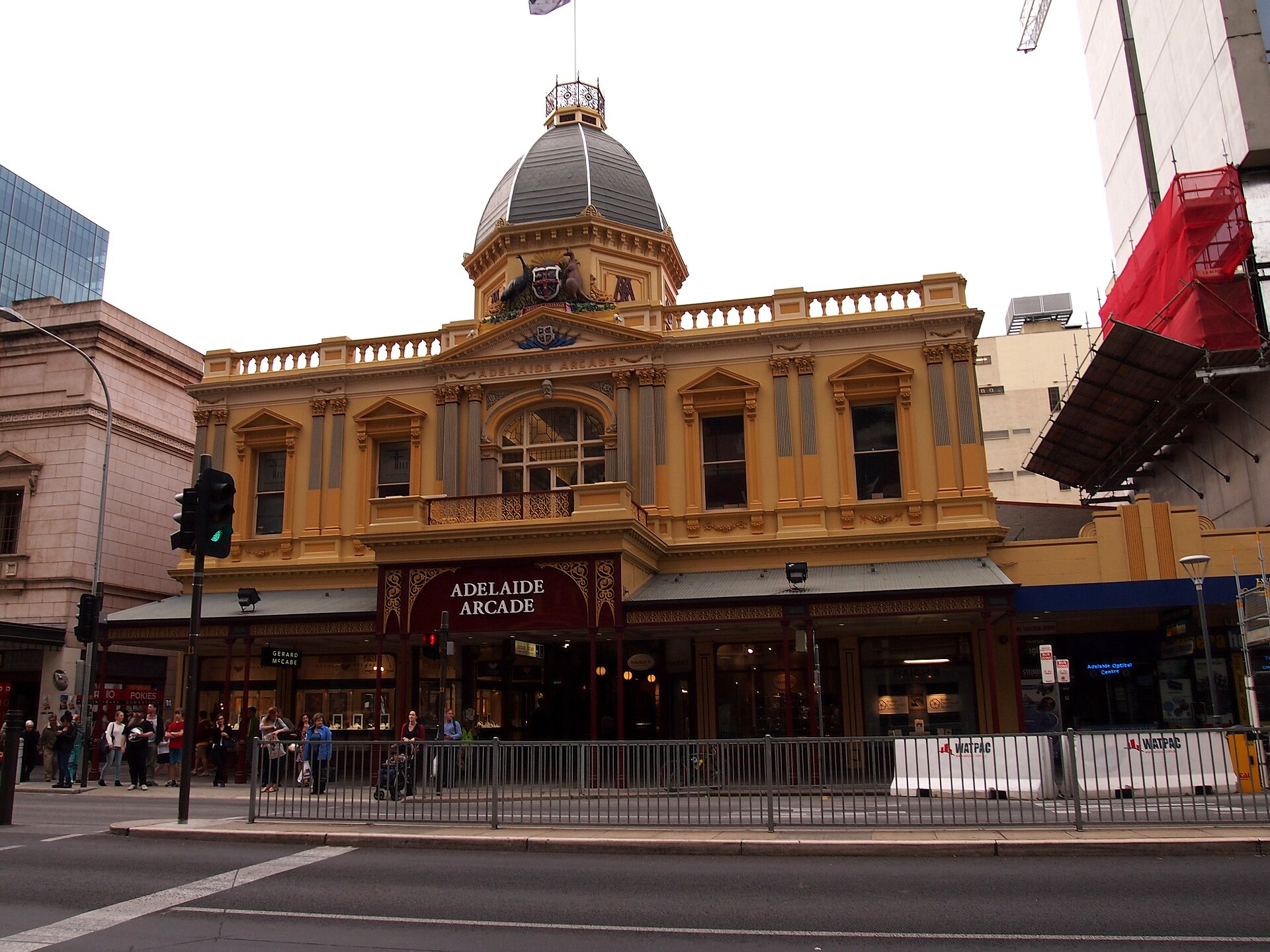 The domed cream-and-gold Victorian street frontage of the Adelaide Arcade with its name above the entrance