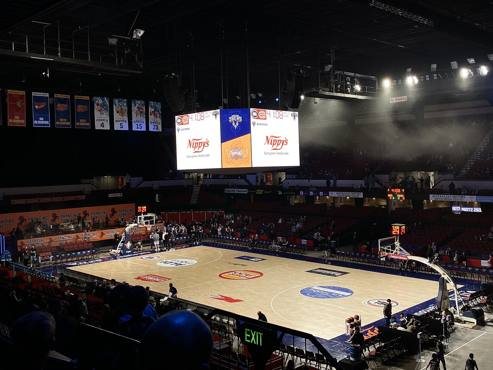 The Adelaide Entertainment Centre set up for a basketball game with championship banners hanging above the court