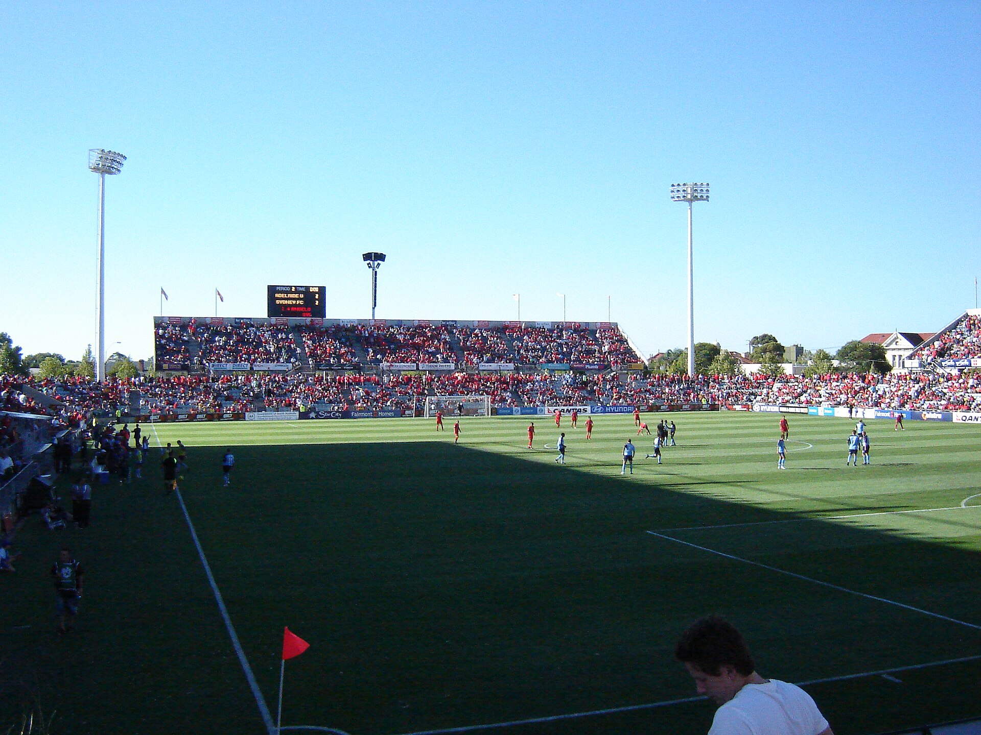 A crowd in red fills the grandstand and terraces at Coopers Stadium in Hindmarsh during an Adelaide United match