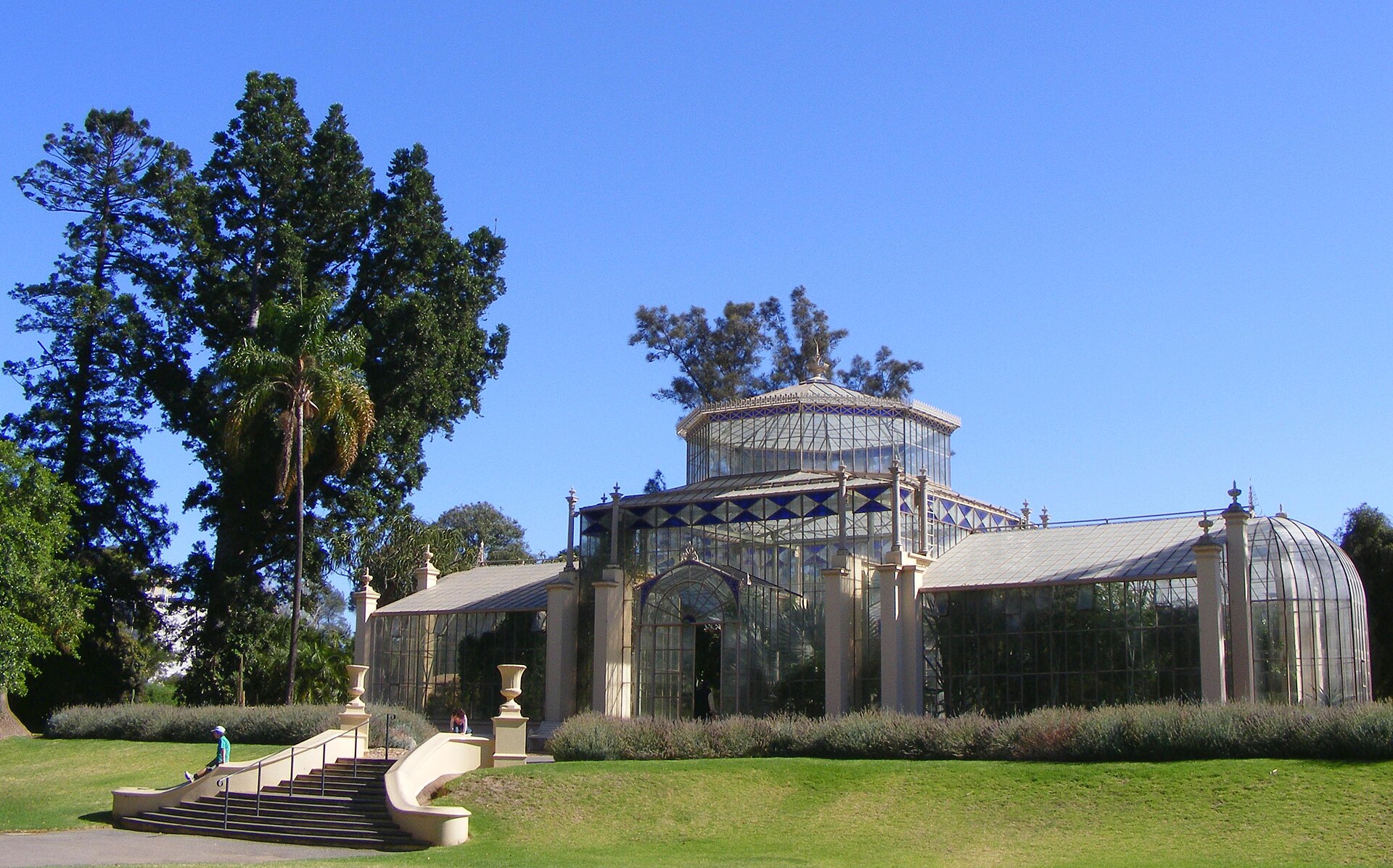 The Victorian glasshouse Palm House in the Adelaide Botanic Garden surrounded by lawns and trees