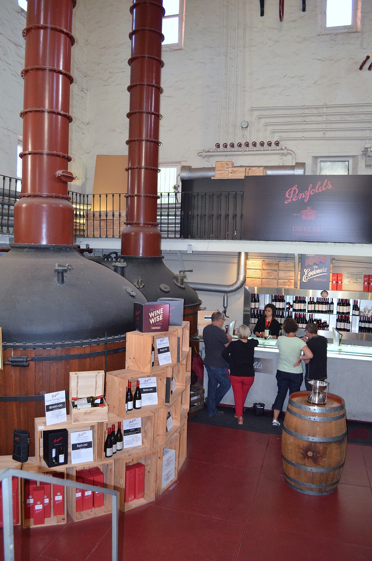 Inside the Magill Estate cellar door in 2014, with tall copper stills rising above the tasting counter and displays of wine boxes