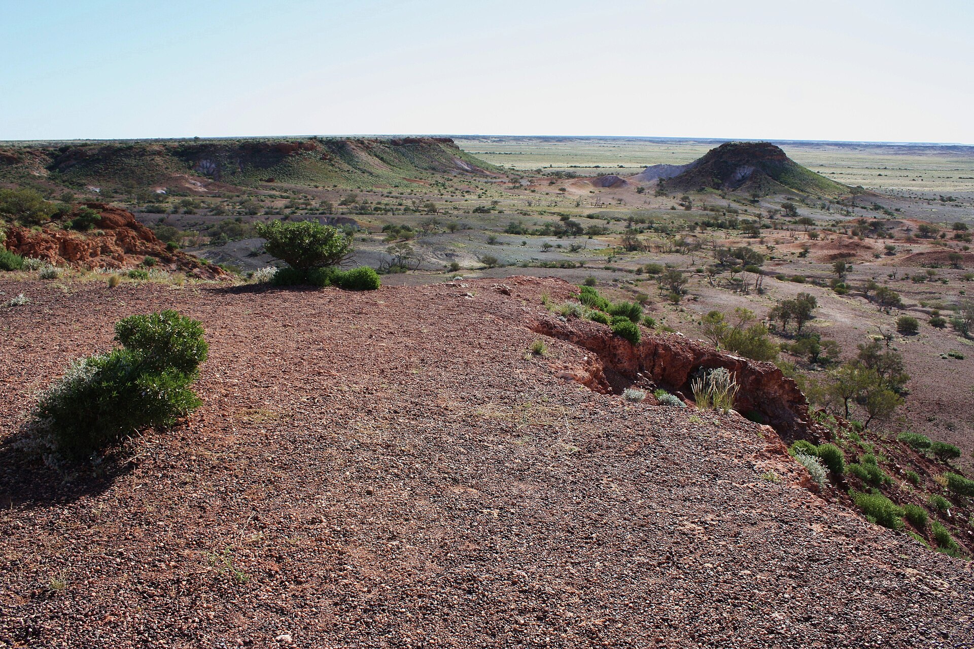 Flat-topped ochre mesas rising from a stony desert plain at the Breakaways near Coober Pedy