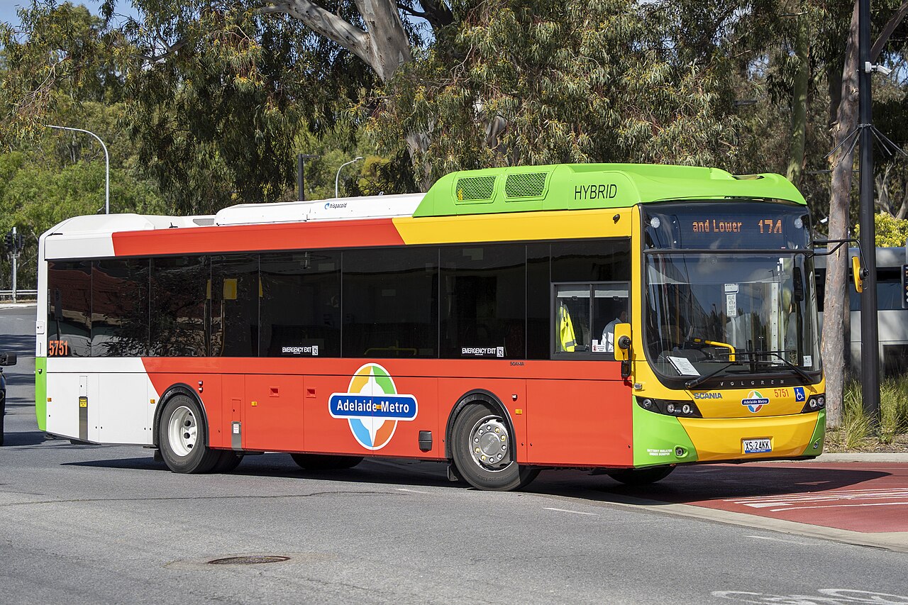 A hybrid Adelaide Metro bus in red, white, yellow and green livery with the Adelaide Metro logo on its side