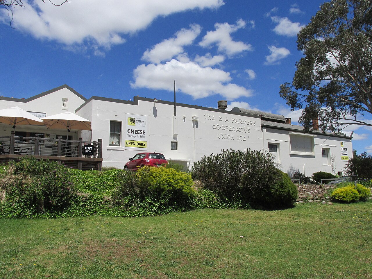 The whitewashed former S.A. Farmers Co-operative Union dairy factory in Woodside, now home to a cheesemaker, with a sign advertising cheese tastings and sales